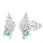 A pair of sterling silver earrings designed to resemble conch seashells with green gemstones set in them.