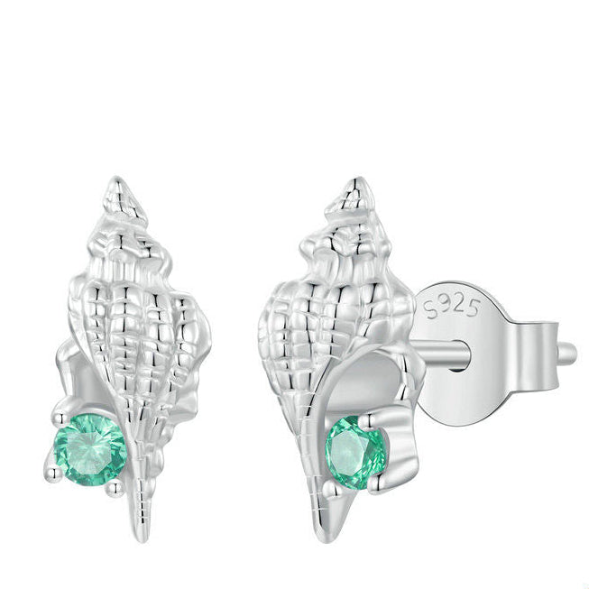 A pair of sterling silver earrings designed to resemble conch seashells with green gemstones set in them.