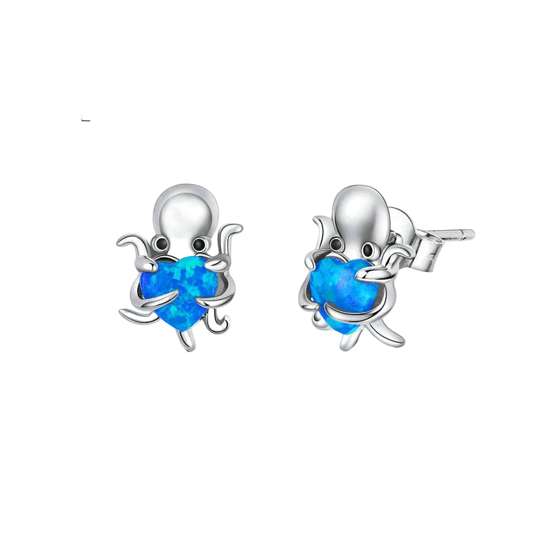 Silver octopus earrings with blue heart stones on a white background