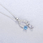 Collier fer à cheval en topaze bleue