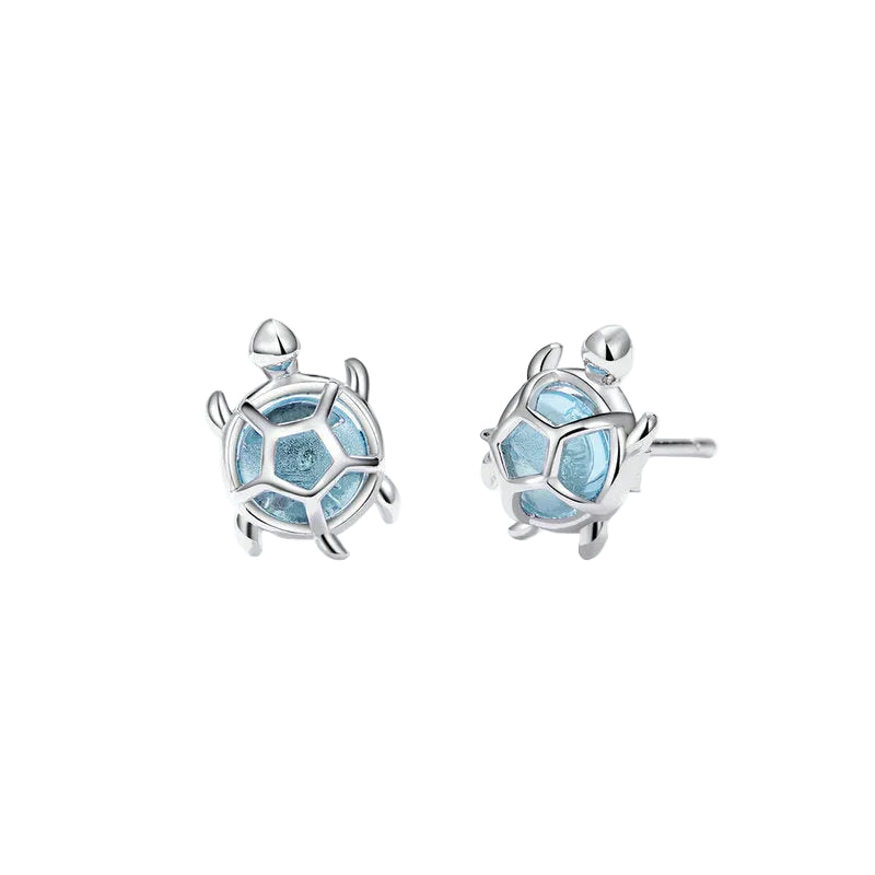 Silver turtle-shaped earrings with blue accents on a white background