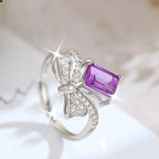 Silver ring with a purple gemstone on a light background