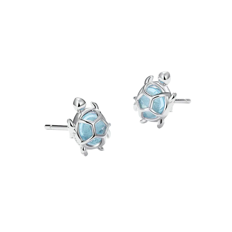 Silver earrings with blue gemstones on a white background