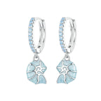 Silver earrings with blue floral designs on a white background