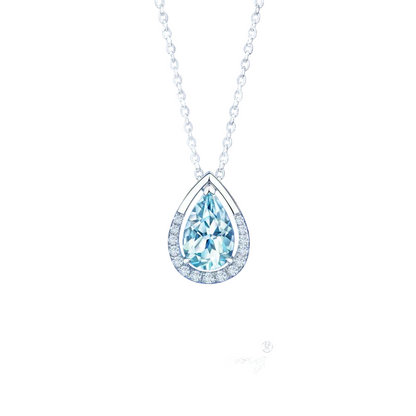 A teardrop-shaped pendant necklace featuring a light blue gemstone surrounded by a silver halo, suspended from a silver chain against a dark blue gradient background. 