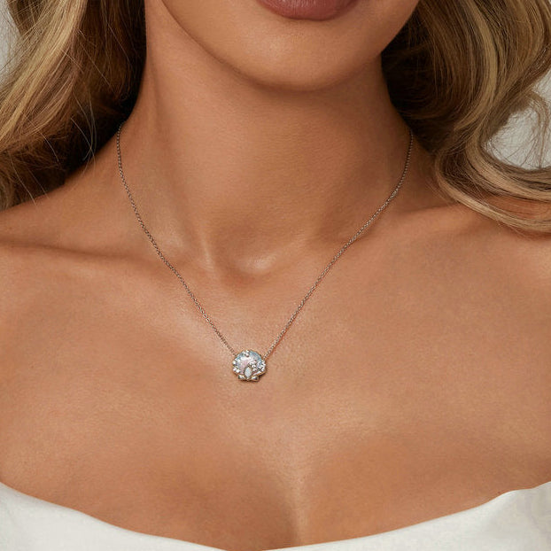 Woman wearing a necklace on a neutral background