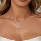 Woman wearing a necklace on a neutral background