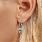 Close-up of an ear wearing a floral earring 