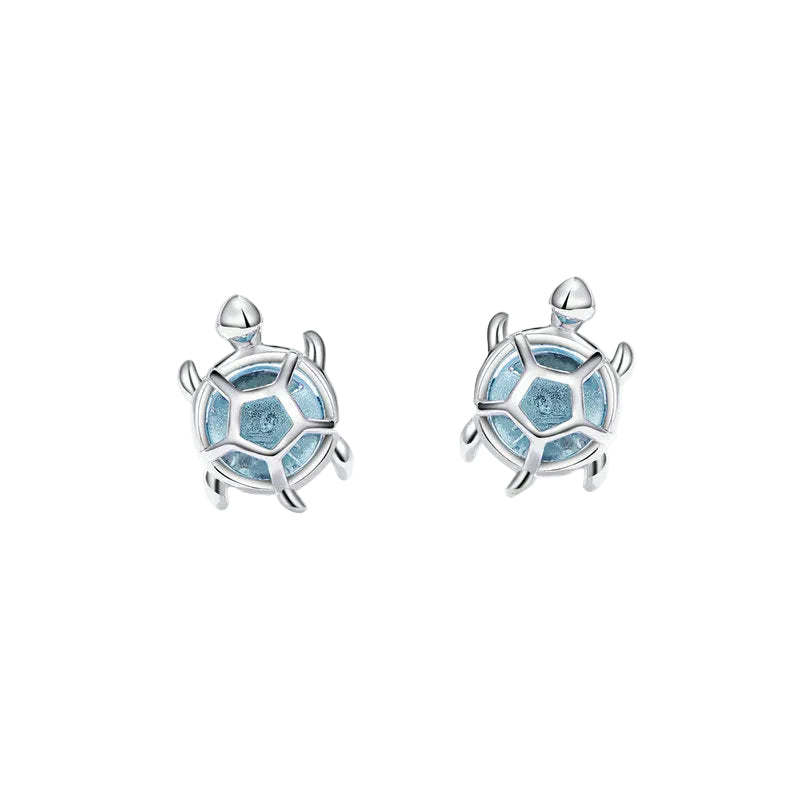 Silver turtle-shaped earrings with blue accents on a white background