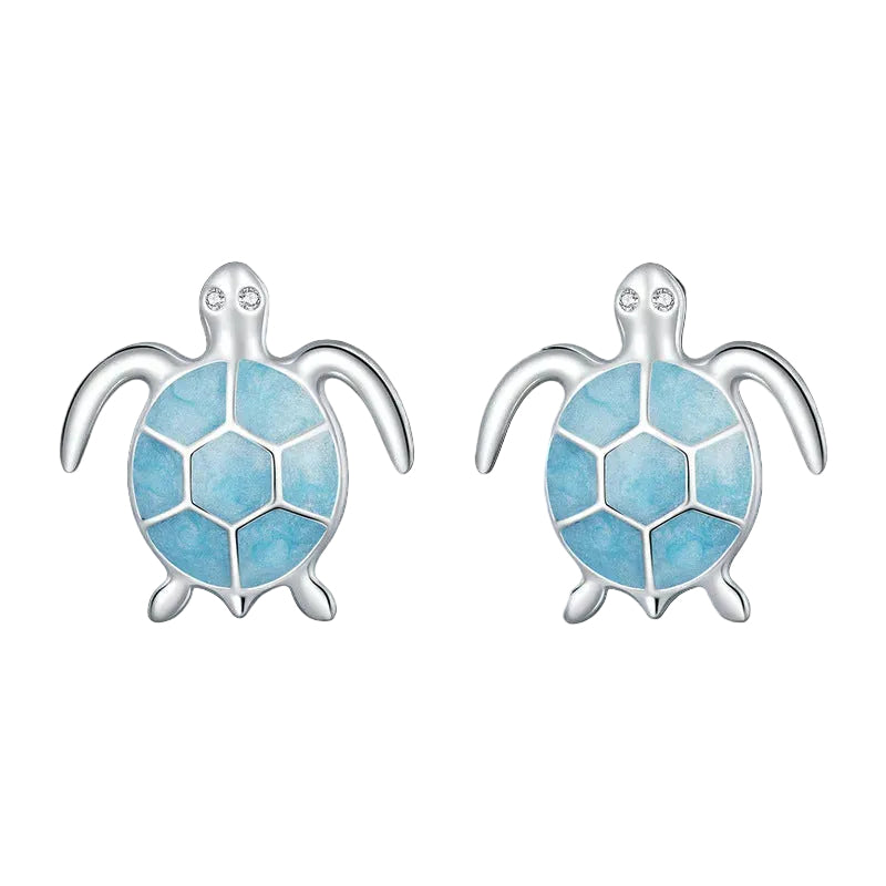 Turtle-shaped earrings with blue design and silver frame on a white background.