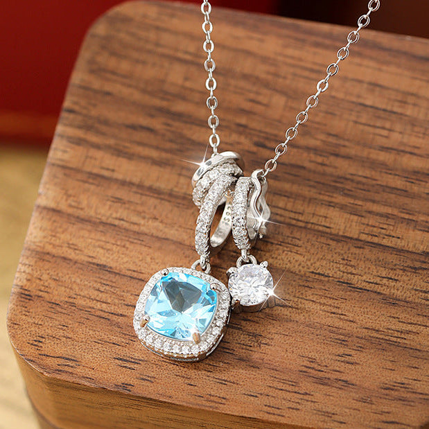 Necklace with a blue gemstone pendant on a wooden surface