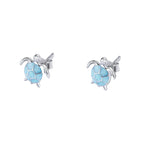 Tortoise-shaped earrings with blue center and silver frame on a white background, featuring EIFFIE brand logo.