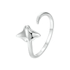 Silver ring with a star design on a white background